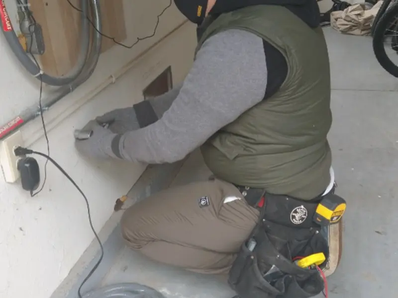 Electrician performing outlet wiring in a Pohatcong garage